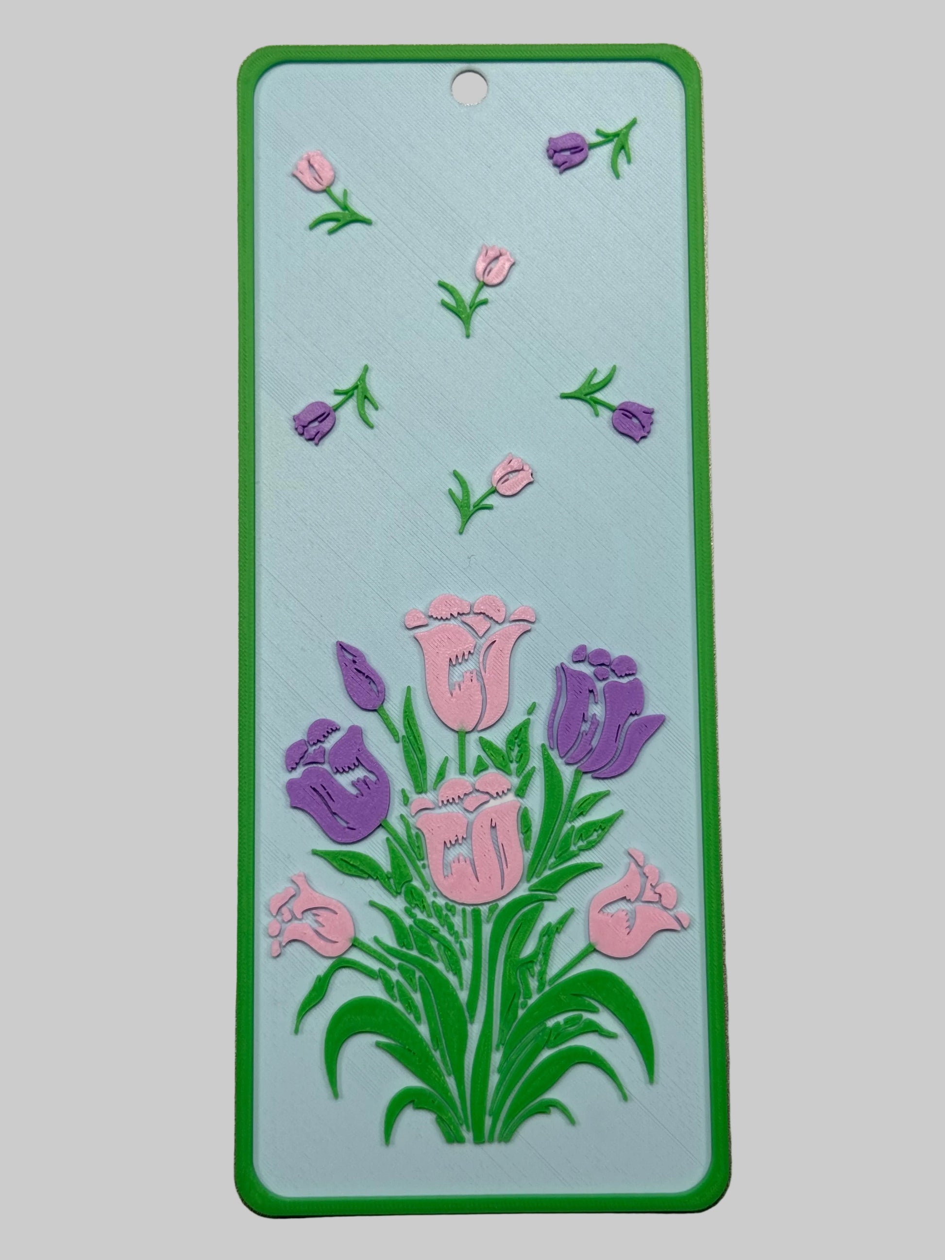 Floral design on a rectangular card with a green border against a metallic background