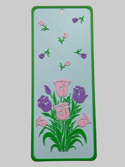 Floral design on a rectangular card with a green border against a metallic background
