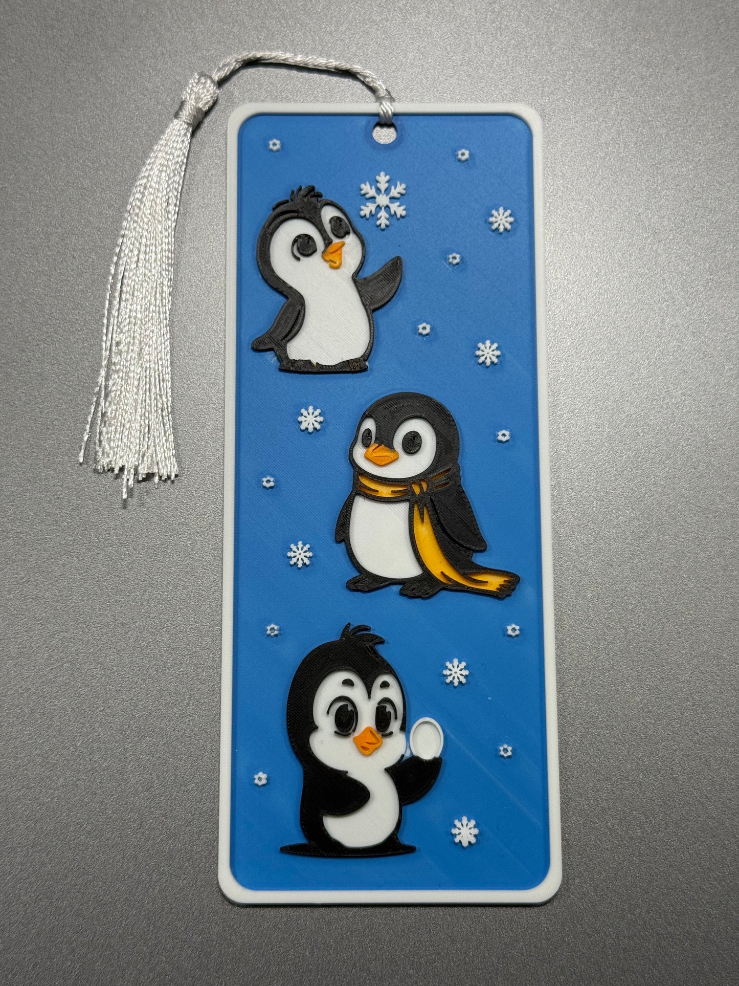 Bookmark with penguin design on a blue background